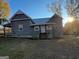 View of back exterior of house with yard and patio at 59 S Old Hwy 27, Roopville, GA 30170