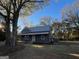 Charming gray home with a metal roof, inviting porch, and mature landscaping at 59 S Old Hwy 27, Roopville, GA 30170