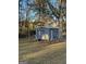 A metal outbuilding featuring a garage door and a single door at 59 S Old Hwy 27, Roopville, GA 30170