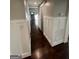 Hallway featuring dark wood flooring and white wainscoting at 59 S Old Hwy 27, Roopville, GA 30170