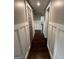 Hallway with hardwood floors, white wainscoting, leading to various rooms in the home at 59 S Old Hwy 27, Roopville, GA 30170