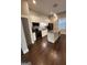 Modern kitchen featuring granite countertops, island, stainless steel appliances, and chic pendant lighting at 59 S Old Hwy 27, Roopville, GA 30170