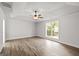 Spacious bedroom with wood-look floors and large window with backyard view at 3261 Broadnax Mill Rd # 2, Loganville, GA 30052