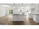 Spacious kitchen featuring modern appliances, granite countertops, kitchen island and wood floors at 3261 Broadnax Mill Rd # 2, Loganville, GA 30052