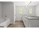 A stylish bathroom featuring double sinks with granite counters and a tub at 3251 Broadnax Mill Rd # 3, Loganville, GA 30052