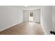 A bright bedroom with wood floors, a window and an open door to another room at 3251 Broadnax Mill Rd # 3, Loganville, GA 30052