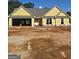 New construction with yellow siding, large front windows, and an attached two-car garage in a suburban neighborhood at 3245 Broadnax Mill Rd # 7, Loganville, GA 30052