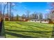 Large backyard with manicured lawn showcasing a shed, wooden fence and the home's exterior at 5109 Dogwood Hills Dr, Sugar Hill, GA 30518