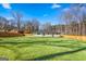 Expansive backyard with lush lawn, leading to a cozy ranch home and wooden privacy fence at 5109 Dogwood Hills Dr, Sugar Hill, GA 30518