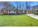 Charming ranch home with manicured lawn and an elegant stone garden in a verdant setting at 5109 Dogwood Hills Dr, Sugar Hill, GA 30518