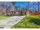 Charming brick home featuring a covered carport, well-manicured lawn, and inviting curb appeal at 5109 Dogwood Hills Dr, Sugar Hill, GA 30518