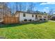 Charming ranch home with manicured lawn and an elegant stone garden in a verdant setting at 5109 Dogwood Hills Dr, Sugar Hill, GA 30518