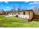 Exterior side view of a white brick home with a lush green lawn and privacy fence at 5109 Dogwood Hills Dr, Sugar Hill, GA 30518