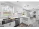 Modern kitchen boasts farmhouse sink, stainless appliances, and stylish backsplash at 5109 Dogwood Hills Dr, Sugar Hill, GA 30518