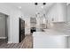 Bright modern kitchen with white cabinets, quartz counters, stainless appliances, and stylish backsplash at 5109 Dogwood Hills Dr, Sugar Hill, GA 30518