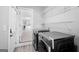 Well-lit laundry room with modern washer and dryer, open to kitchen beyond doorway at 5109 Dogwood Hills Dr, Sugar Hill, GA 30518
