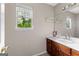 Bathroom featuring a window above the sink, with tree views and a cabinet underneath at 130 Ashley Trace Dr, Locust Grove, GA 30248