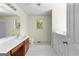 Bathroom with wood cabinets, white sink, toilet, tile flooring, window, and a bath tub nearby at 130 Ashley Trace Dr, Locust Grove, GA 30248