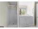 Bathroom featuring walk in shower, bath tub, window, and metal hand rails at 130 Ashley Trace Dr, Locust Grove, GA 30248