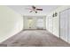Bright bedroom with carpet, featuring two windows, two closets, and a ceiling fan at 130 Ashley Trace Dr, Locust Grove, GA 30248