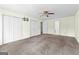 Spacious bedroom features large closets, carpet, ceiling fan, and natural light streaming through multiple windows at 130 Ashley Trace Dr, Locust Grove, GA 30248