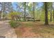 Quaint one-story home featuring a quaint front porch and mature trees at 130 Ashley Trace Dr, Locust Grove, GA 30248