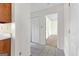 Hallway with tile flooring leads to a bedroom with closet, featuring neutral paint throughout the space at 130 Ashley Trace Dr, Locust Grove, GA 30248