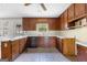 The kitchen showcases wood cabinets, tile flooring, a black dishwasher, and a window above the sink area at 130 Ashley Trace Dr, Locust Grove, GA 30248