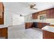Bright kitchen offers ample space, wood cabinets, tiled floors, and great natural light from the nearby window at 130 Ashley Trace Dr, Locust Grove, GA 30248
