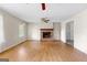 Living room with hardwood flooring and brick fireplace at 130 Ashley Trace Dr, Locust Grove, GA 30248