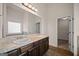Bright bathroom featuring double sinks, granite counters, and a large mirror at 2381 Aukerman Trce # 81, Hampton, GA 30228
