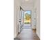 Inviting foyer with hardwood floors and a view of the landscaped front yard through the front door at 2381 Aukerman Trce # 81, Hampton, GA 30228
