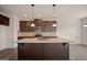 Kitchen featuring granite counters, a central island with a sink, and a stainless steel appliance package at 2381 Aukerman Trce # 81, Hampton, GA 30228