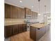 Spacious kitchen with dark wood cabinets, granite countertops, stainless steel appliances, and an island at 2381 Aukerman Trce # 81, Hampton, GA 30228