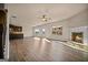 Open-concept living room with wood floors, a cozy fireplace, and views into the modern kitchen at 2381 Aukerman Trce # 81, Hampton, GA 30228
