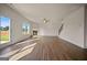 Open-concept living room with hardwood floors, fireplace, ceiling fan and abundant natural light at 2381 Aukerman Trce # 81, Hampton, GA 30228