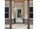 Charming front entrance with a stylish white door, stone accents, and dark wood columns at 6093 Wayfarer Dr, Villa Rica, GA 30180