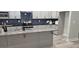 Modern kitchen with granite countertops, gray cabinetry, stainless steel appliances and a large island at 6093 Wayfarer Dr, Villa Rica, GA 30180
