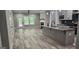 Open-concept kitchen and living area with an island, modern cabinets, and hardwood floors at 6093 Wayfarer Dr, Villa Rica, GA 30180