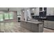 This stylish kitchen features gray cabinets, granite countertops, and stainless steel appliances at 6093 Wayfarer Dr, Villa Rica, GA 30180