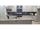Modern kitchen with granite countertops, gray cabinetry, stainless steel appliances and a large island at 6093 Wayfarer Dr, Villa Rica, GA 30180