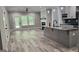 Open-concept kitchen and living area with an island, modern cabinets, and hardwood floors at 6093 Wayfarer Dr, Villa Rica, GA 30180