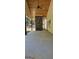 Spacious outdoor patio featuring a stone fireplace, wood ceiling, and ample room for entertaining at 6093 Wayfarer Dr, Villa Rica, GA 30180