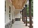 Inviting porch featuring exposed wood ceiling, stone accents, and classic architectural details at 6093 Wayfarer Dr, Villa Rica, GA 30180