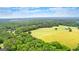 Scenic aerial view showcases land, trees, pond, and country home at 290 Weldon Rd, Fayetteville, GA 30215