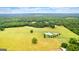 Sprawling aerial view of country estate with long drive, pasture, trees, and horse area at 290 Weldon Rd, Fayetteville, GA 30215