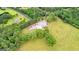 Aerial view of acreage property with barn, mature trees and expansive fields, offering serene countryside living at 290 Weldon Rd, Fayetteville, GA 30215