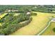 Expansive, lush green acreage property featuring a mix of open fields and wooded areas at 290 Weldon Rd, Fayetteville, GA 30215