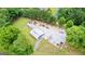 Aerial perspective of acreage property featuring large barn, mature trees and expansive fields at 290 Weldon Rd, Fayetteville, GA 30215