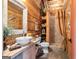 Rustic bathroom featuring wood paneling, a vessel sink, and walk in shower with vintage accents at 290 Weldon Rd, Fayetteville, GA 30215